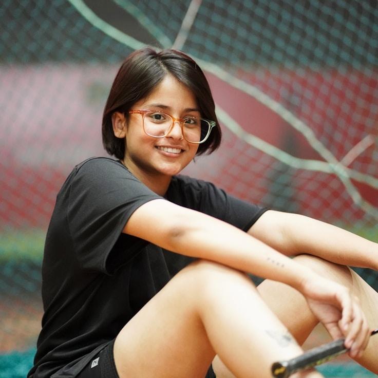 Alex Morgan, Lead Design Curator at Opal Meadow Ridge, reviewing corporate floral arrangements